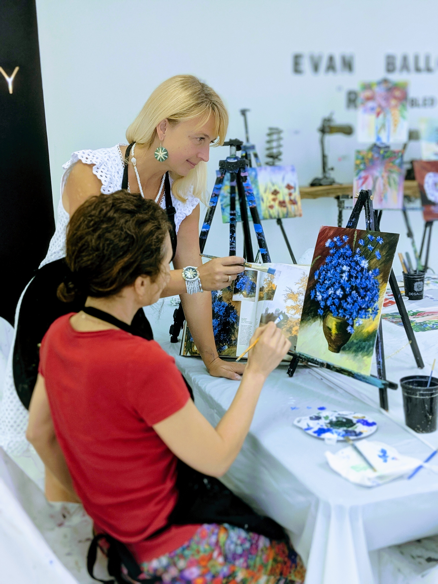 Dary teaching a student painting